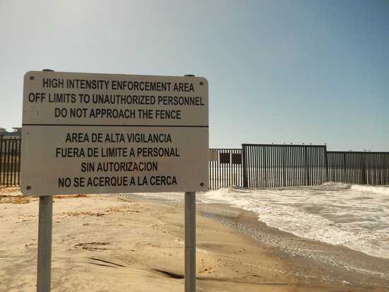 Photo of a signpost threatening violence outside the gated border.